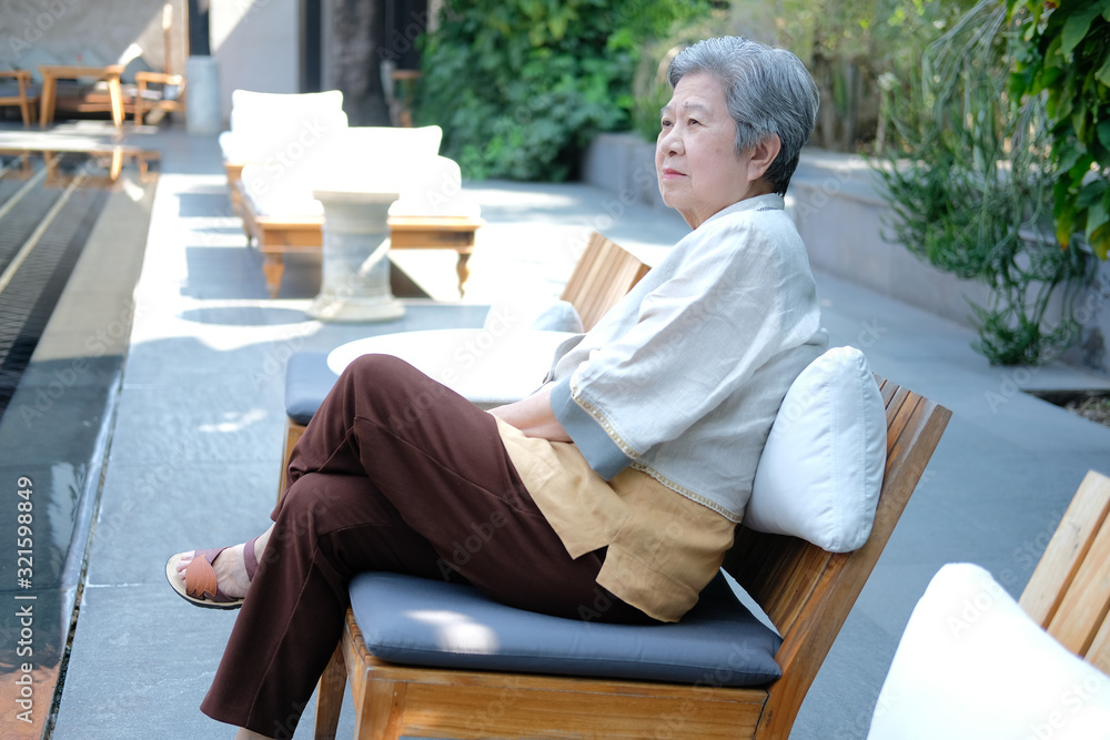 old elderly senior elder woman resting relaxing at poolside of swimming pool in hotel old elderly senior elder woman resting relaxing at poolside of swimming pool in hotel