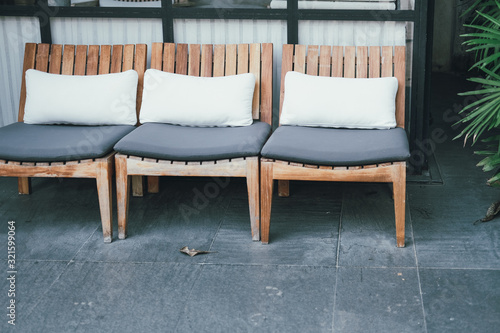 Wallpaper Mural pillow cushion on wooden chair in hotel resort for relaxing outdoor Torontodigital.ca
