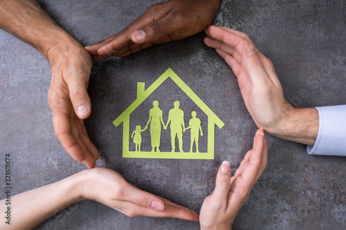 Person Hands Protecting Family Home photo