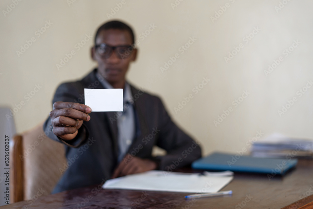 Africa is the future: black African native businessman showing personal business ID calling card to you, with copy space replace your card Africa is the future: black African native businessman showing personal business ID calling card to you, with copy space replace your card