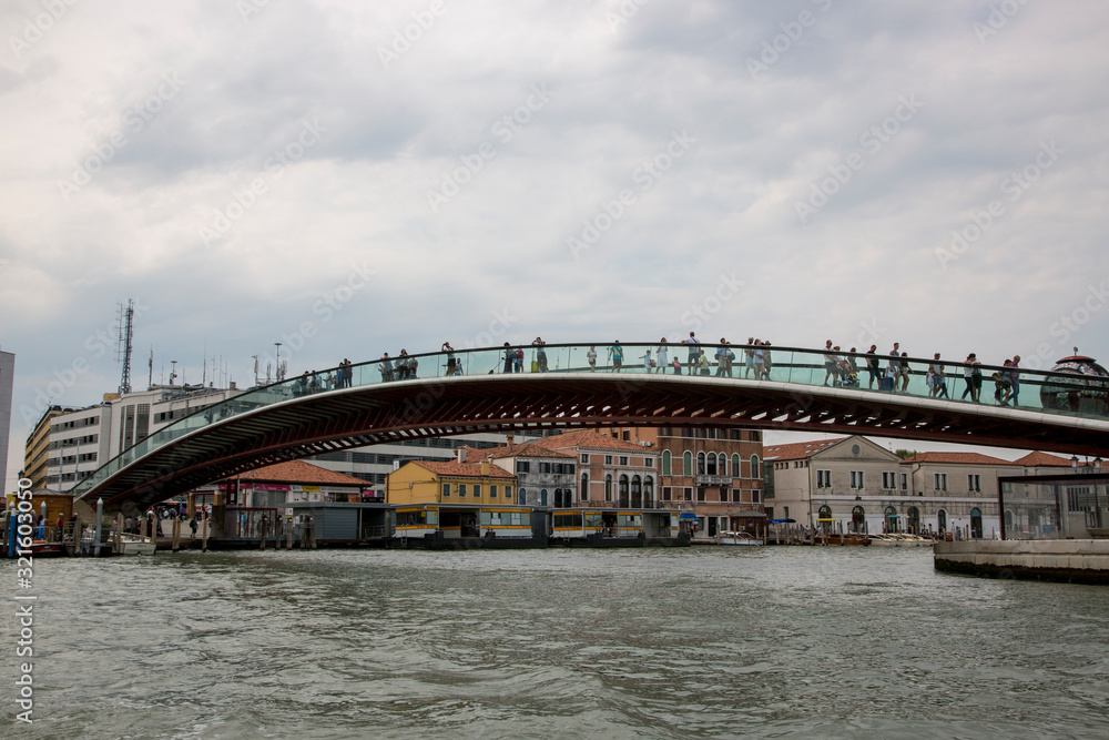 Naklejka premium People on the glass Constitution Bridge over the Grand Canal in Venice