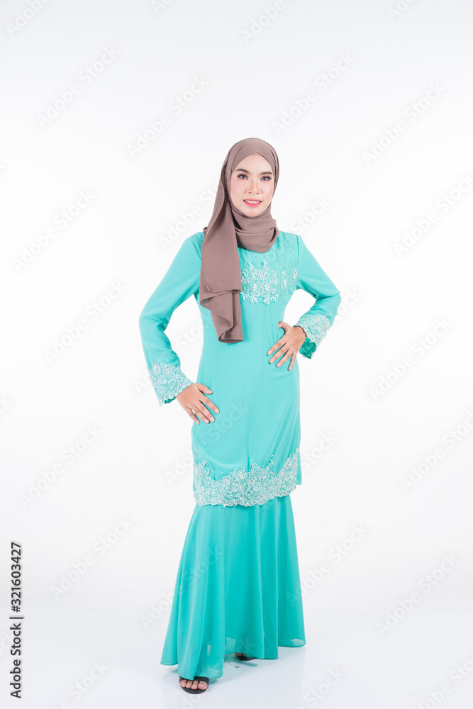 Beautiful female Muslim model in various poses wearing modern kurung and hijab, a modern lifestyle apparel for Muslim women isolated on white. Beauty and hijab fashion concept. Full length portrait Beautiful female Muslim model in various poses wearing modern kurung and hijab, a modern lifestyle apparel for Muslim women isolated on white. Beauty and hijab fashion concept. Full length portrait