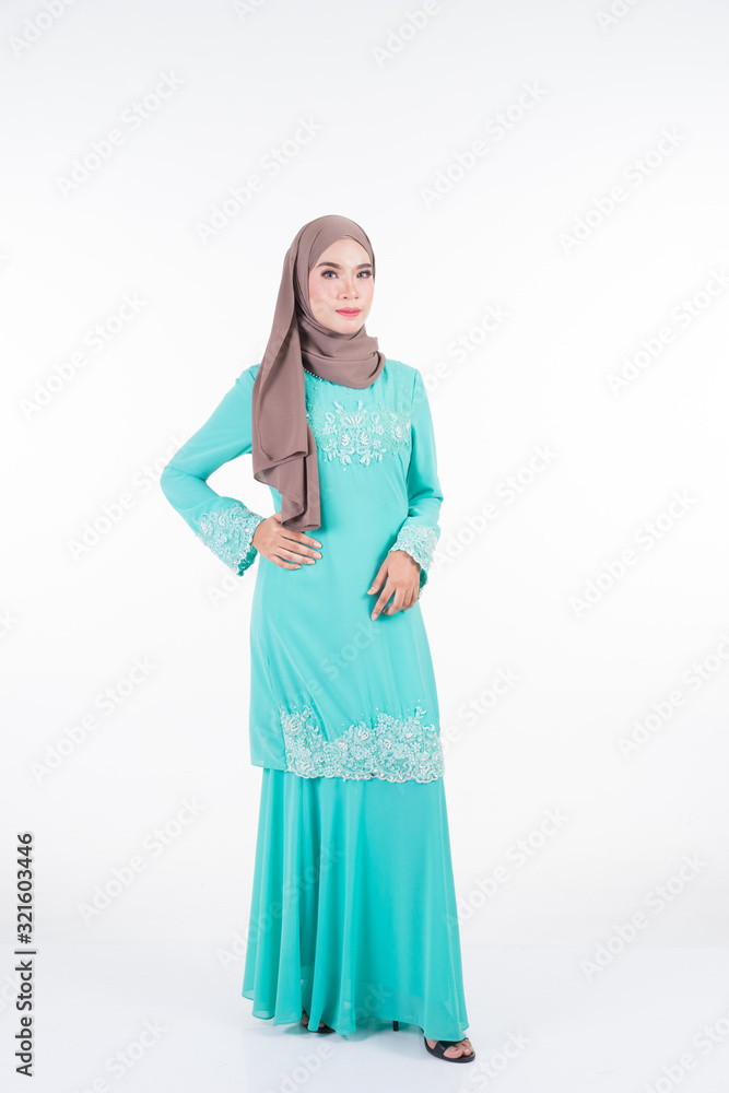 Beautiful female Muslim model in various poses wearing modern kurung and hijab, a modern lifestyle apparel for Muslim women isolated on white. Beauty and hijab fashion concept. Full length portrait Beautiful female Muslim model in various poses wearing modern kurung and hijab, a modern lifestyle apparel for Muslim women isolated on white. Beauty and hijab fashion concept. Full length portrait
