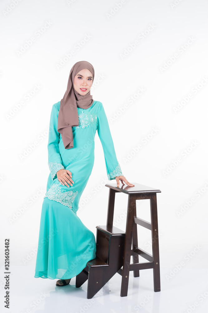 Beautiful female Muslim model in various poses wearing modern kurung and hijab, a modern lifestyle apparel for Muslim women isolated on white. Beauty and hijab fashion concept. Full length portrait Beautiful female Muslim model in various poses wearing modern kurung and hijab, a modern lifestyle apparel for Muslim women isolated on white. Beauty and hijab fashion concept. Full length portrait