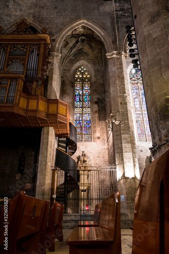 Interior of church with stairs  stained glass window and organ
