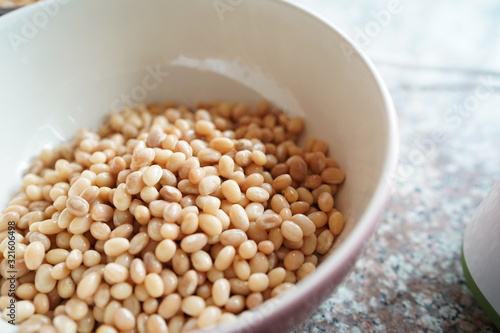 Soybean in hand and soak in water 3 hours before make soy milk.