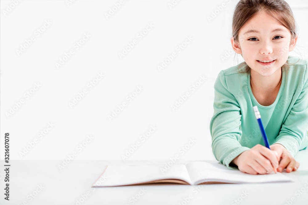 beautiful little girl drawing and do homework on the flloor beautiful little girl drawing and do homework on the flloor