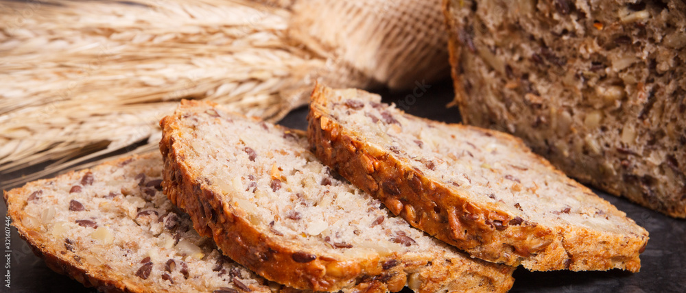 Wholegrain bread for breakfast and ears of rye or wheat grain