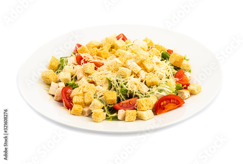 salad of different ingredients on a white plate on a wooden background