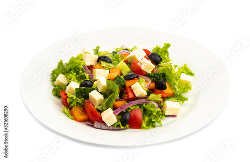 salad of different ingredients on a white plate on a wooden background