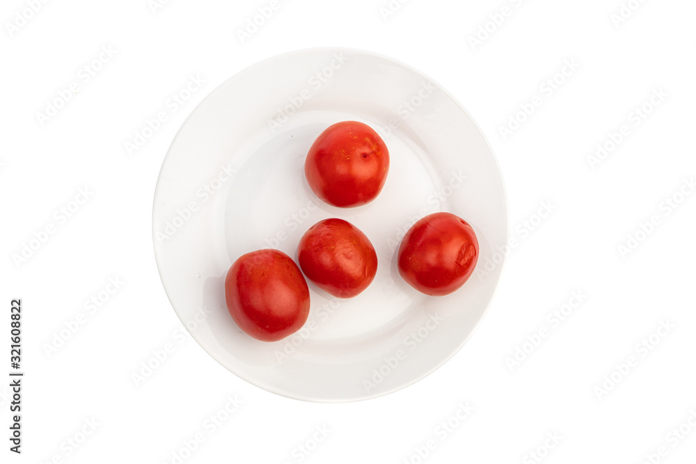 four pickled red tomatoes on a white plate isolated four pickled red tomatoes on a white plate isolated