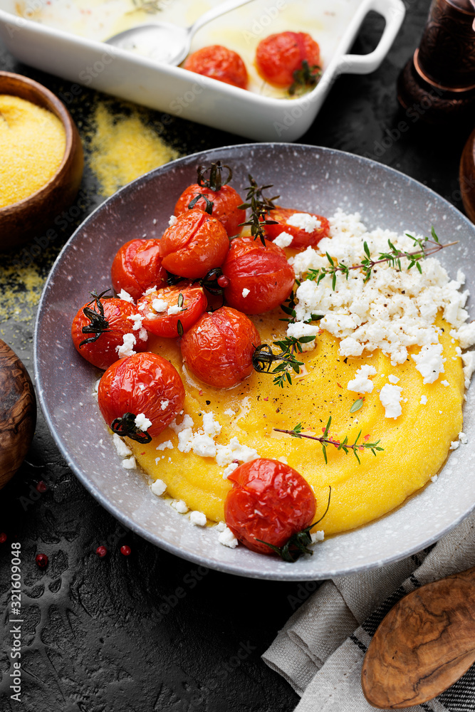 Homemade polenta with grilled cherry tomatoes and ricotta cheese. Homemade polenta with grilled cherry tomatoes and ricotta cheese.