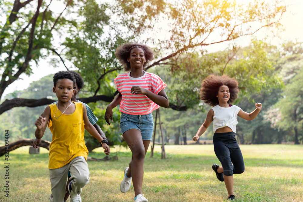 Group of children running in the park, Group of kids running outdoor in summer day.