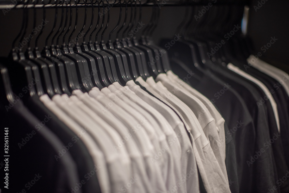 Fototapeta premium Clothing hanging on railing for display in store