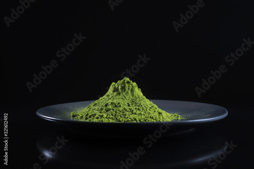 Close-up view powdered matcha tea on black