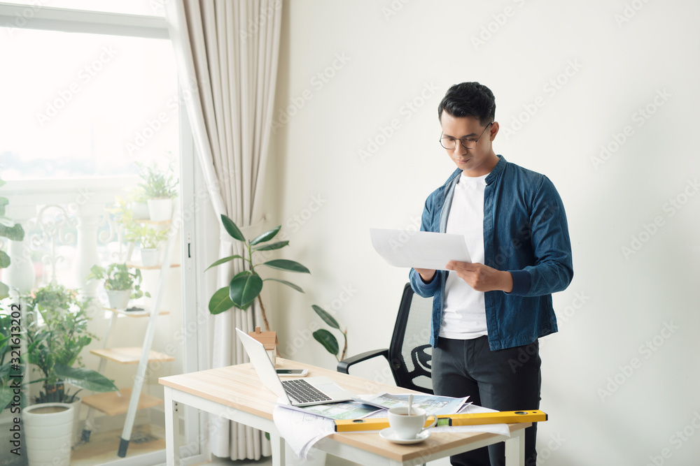 © makistock - architect working at his laptop on the office