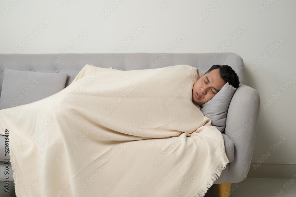 asian eldely sick man feel headache lying on the sofa at home asian eldely sick man feel headache lying on the sofa at home