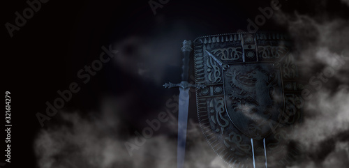 photo of shield knight armor and sword in the fog smoke over dark background. Medieval period concept
