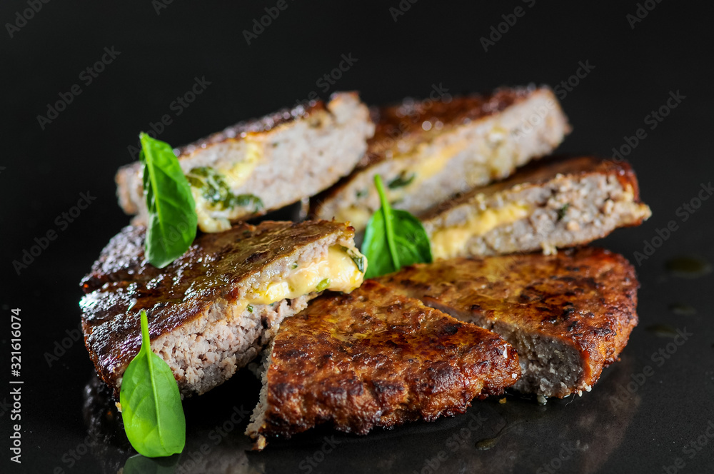 beef steak with cheese on a black glossy background beef steak with cheese on a black glossy background