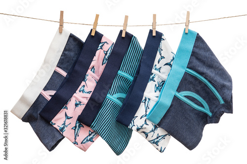 Underwear clothes (underpants) for baby boy hanging on the clothesline isolated on a white background