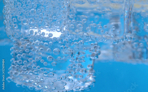 Ice cubes and bubbles in mineral water