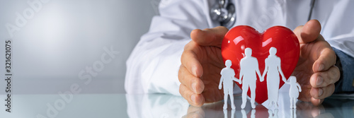 Doctor Protecting Family Cut Out With Heart Shape