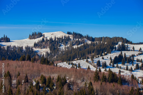 Parvu mountain peak in Poiana Teiului, Romania. 1248m altitude, winter scene photo