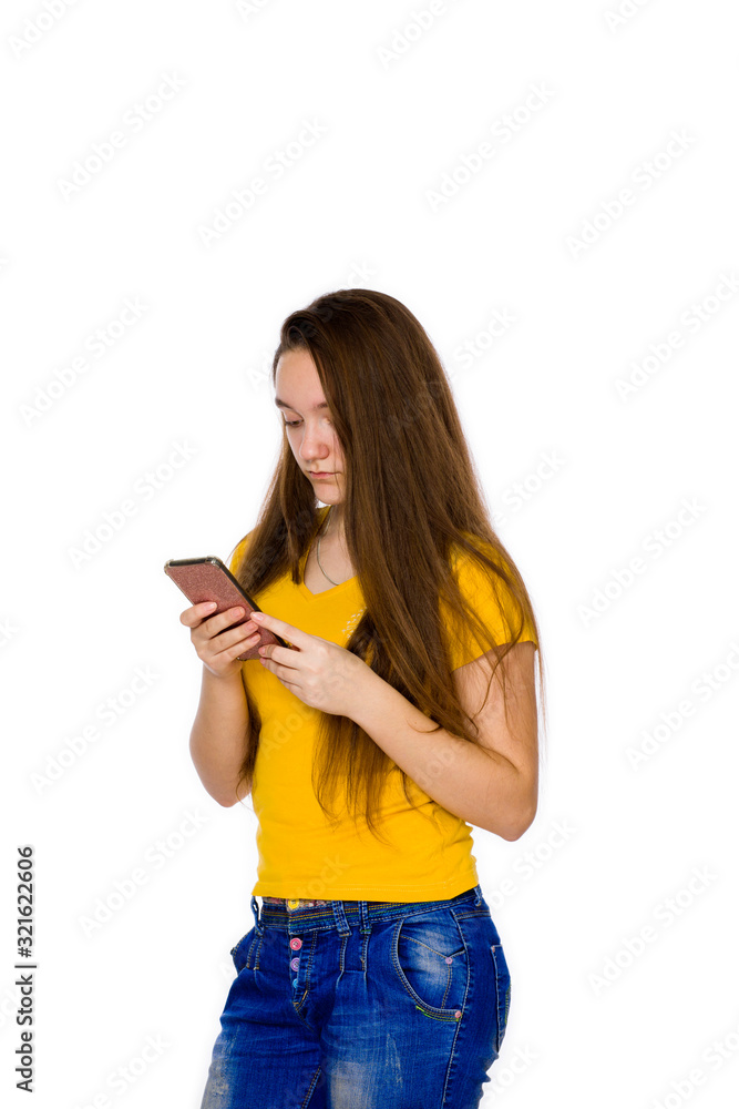 Teenager at the age of 14 with a smartphone on a white background Teenager at the age of 14 with a smartphone on a white background
