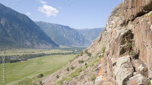 Field, rocks, mountains, river in the Altai Republic in Russia in the summer. Beautiful panorama. Hike