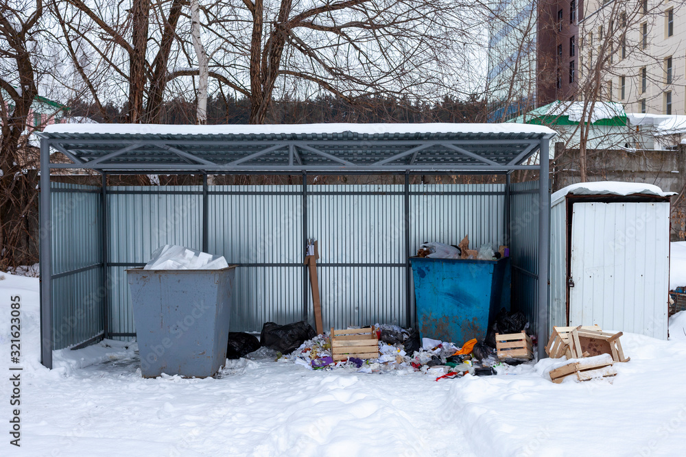 Old rusty garbage cans in the winter. Russia Old rusty garbage cans in the winter. Russia