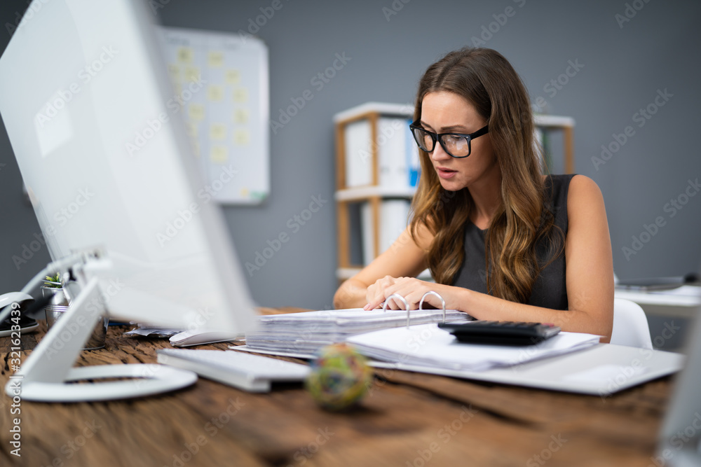 Smiling Businesswoman Calculating Tax Smiling Businesswoman Calculating Tax