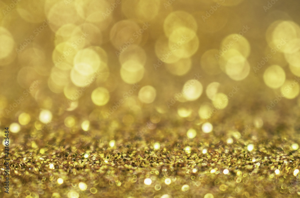 Glitter gold background. Christmas texture with shining Golden circle bokeh as abstract pattern of light color for festive holiday design Glitter gold background. Christmas texture with shining Golden circle bokeh as abstract pattern of light color for festive holiday design