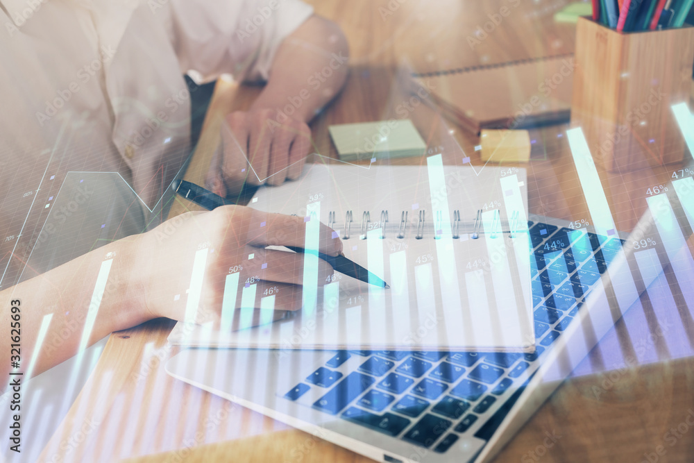 Financial charts displayed on woman's hand taking notes background. Concept of research. Double exposure