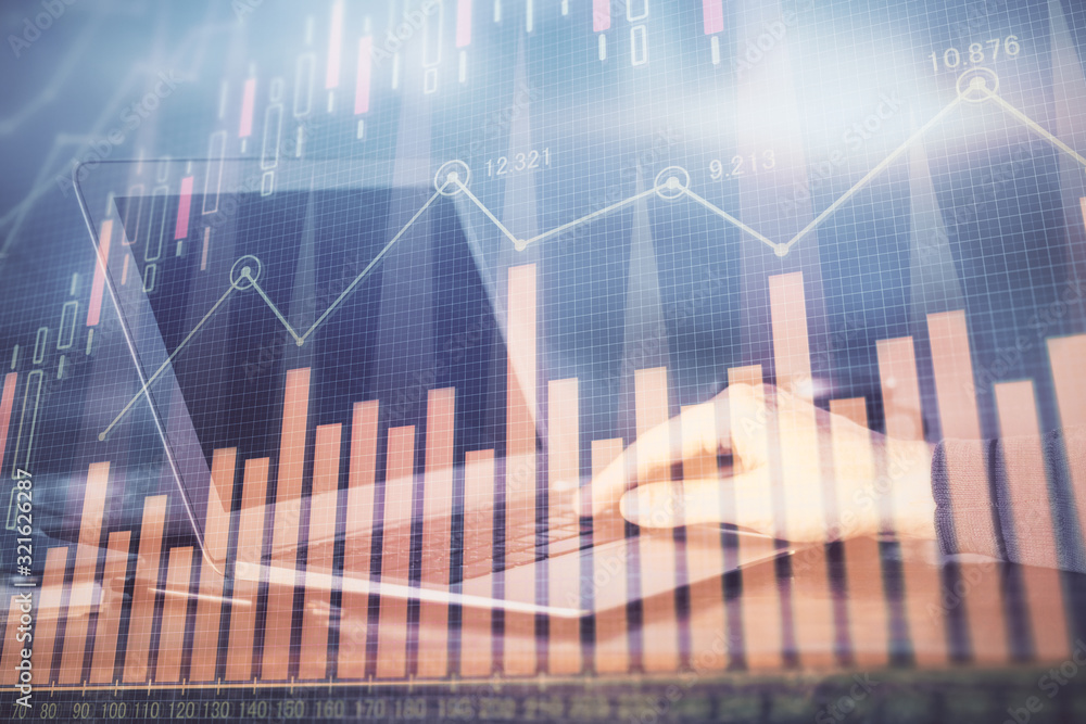 Double exposure of stock market graph with man working on laptop on background. Concept of financial analysis. Double exposure of stock market graph with man working on laptop on background. Concept of financial analysis.