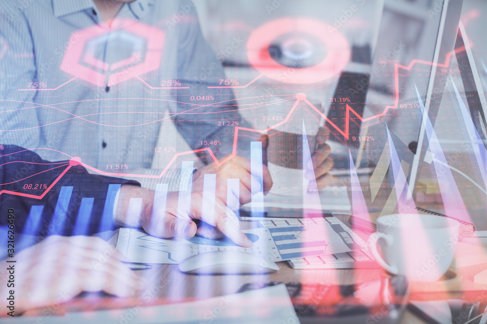 Multi exposure of chart with man typing on computer in office on background. Concept of hard work. Multi exposure of chart with man typing on computer in office on background. Concept of hard work.