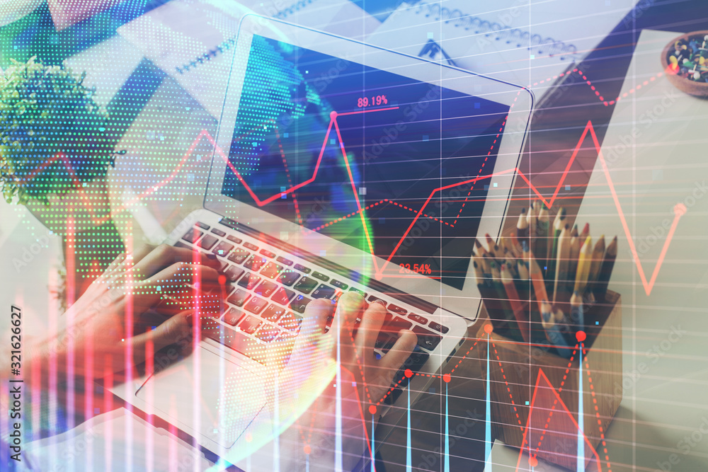 Double exposure of stock graph with businessman typing on computer in office on background. Concept of hard work. Double exposure of stock graph with businessman typing on computer in office on background. Concept of hard work.