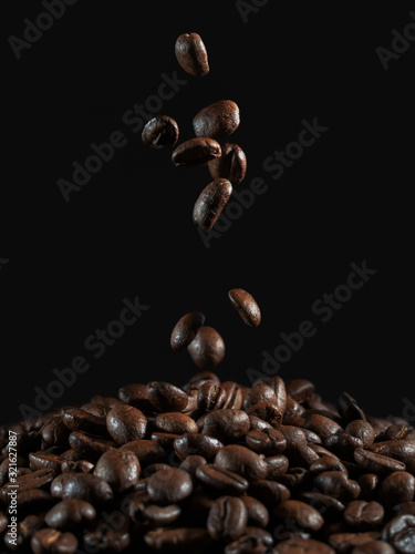 falling coffee beans on the dark background