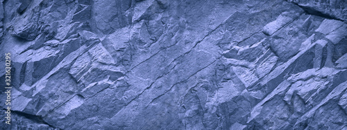 Fototapeta Naklejka Na Ścianę i Meble -  Blue white grunge background. Light blue stone background. Toned mountain texture close-up. Banner with copy space for your design. Decorative volumetric rock background.