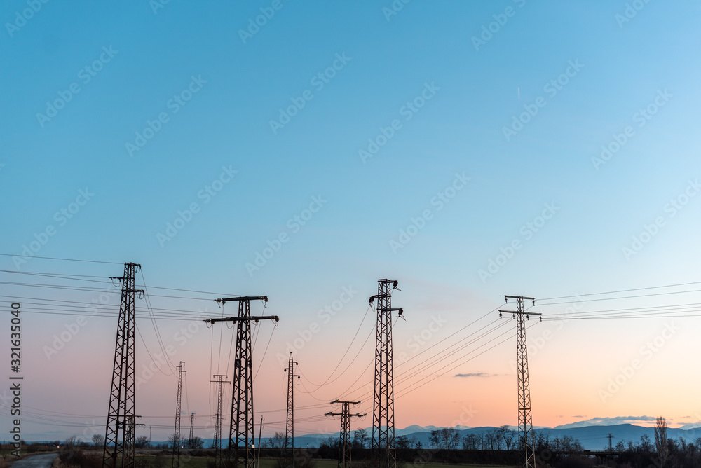 Electric pole telephone cable post sky blue clouds sunset pastel orange copy space