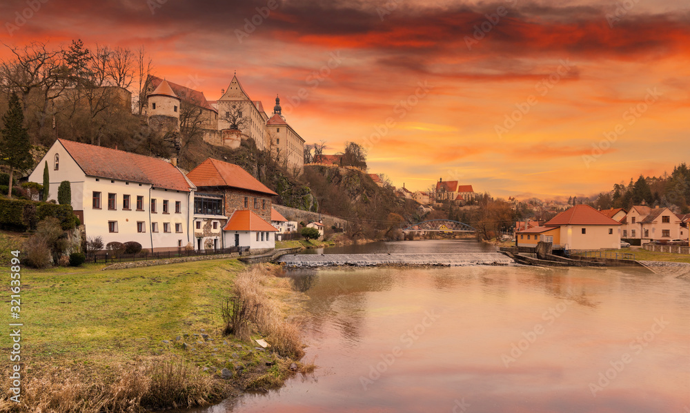 Luznice river and medieval castle Bechyne on a sunset. Czech Republic.