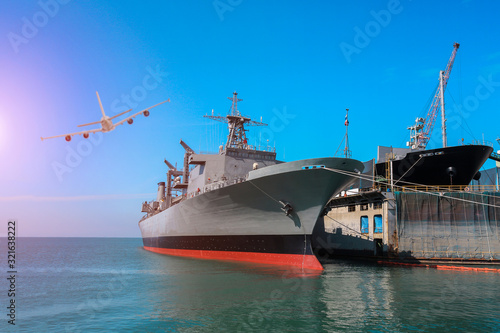 Foto front or prow of military ship moored alongside in shipyard and cargo ship repai