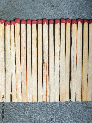 A bunch of matchsticks on a gray background