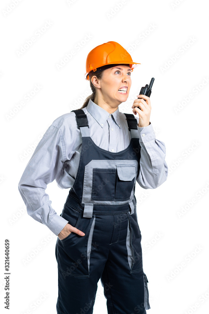 woman civil engineer swears on the walkie-talkie with the workers. Isolated woman civil engineer swears on the walkie-talkie with the workers. Isolated