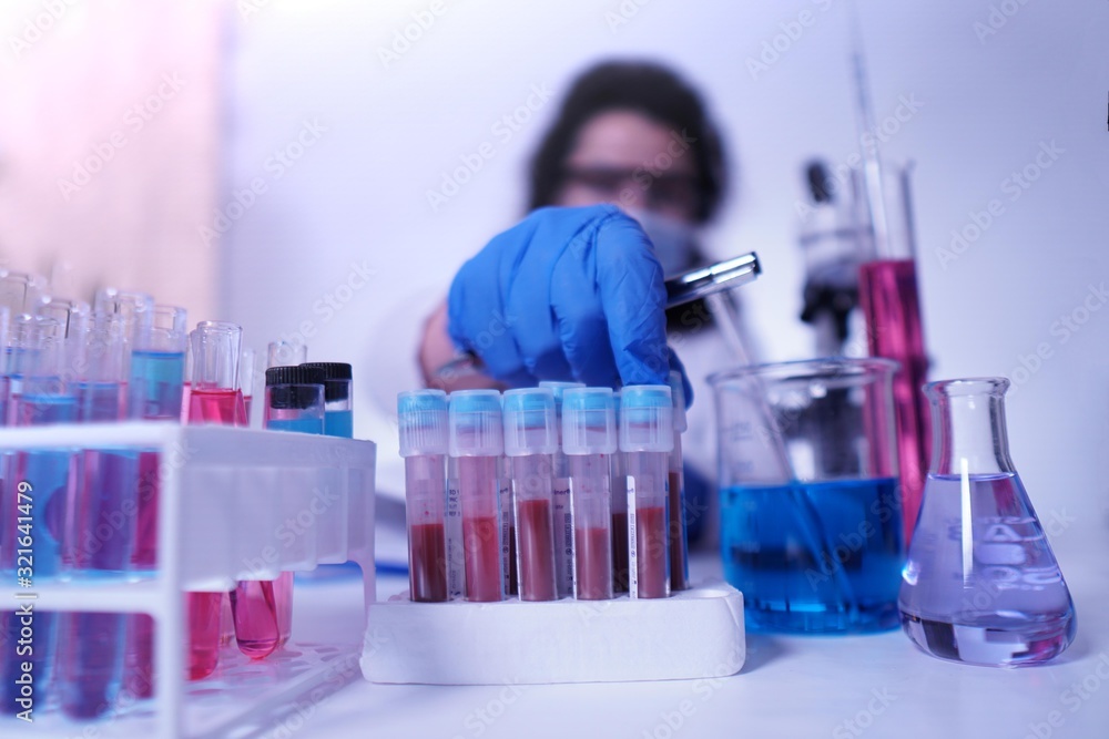 female lab technician doing research with a microscope in the lab. female lab technician doing research with a microscope in the lab.