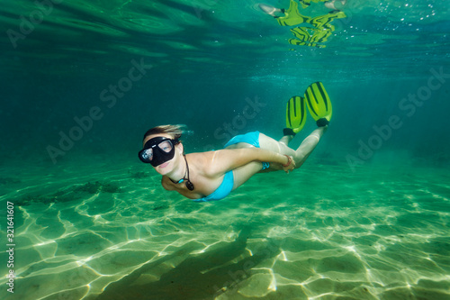 The girl is free diving on the see bottom Adriatic Sea, Croatia