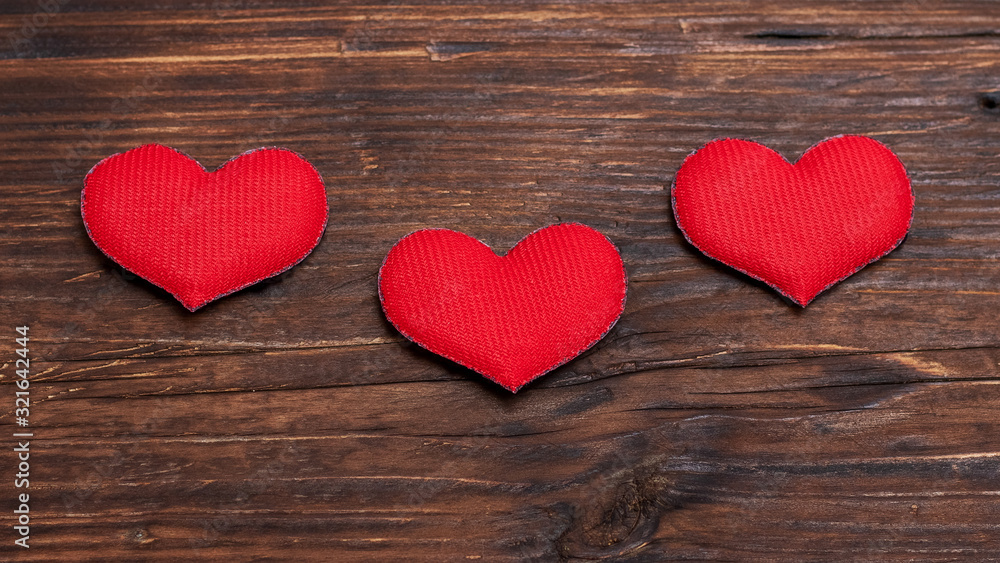 Handmade red hearts on dark wooden background_ Handmade red hearts on dark wooden background_