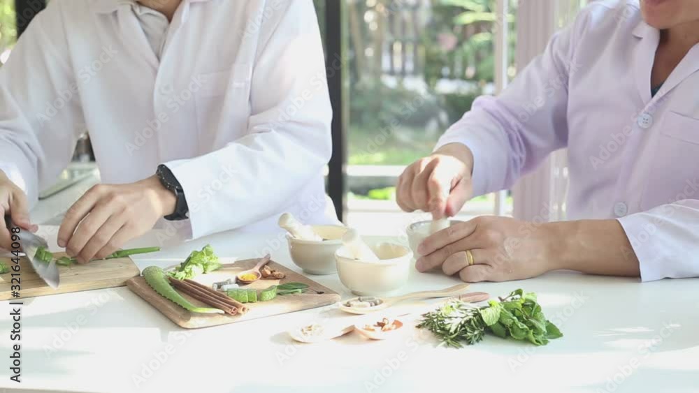Doctors, scientists are doing natural herbal medicine in the laboratory. Grind herbs in a mortar; Doctors, scientists are doing natural herbal medicine in the laboratory. Grind herbs in a mortar;