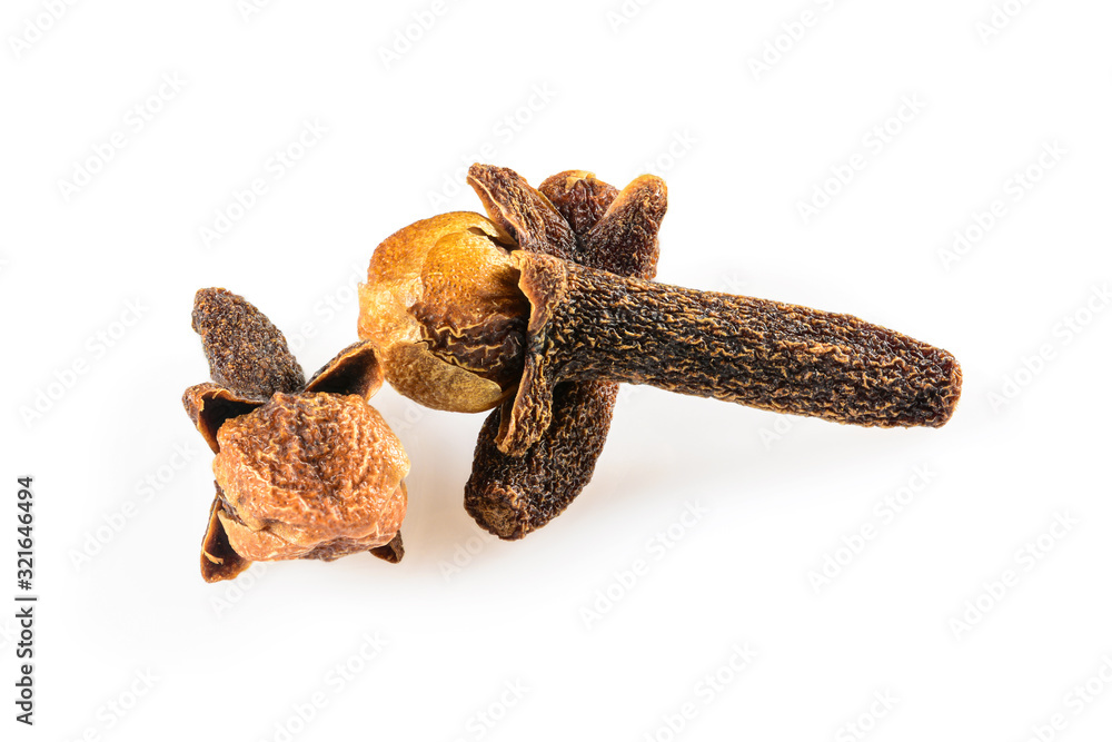 Cloves spice. Three dried cloves, macro close-up Isolated on the white background, with a light shadow. Cloves spice. Three dried cloves, macro close-up Isolated on the white background, with a light shadow.