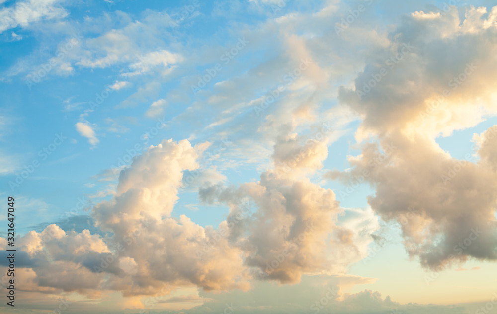 Blue sky clouds background. Beautiful landscape with clouds and orange sun on sky Blue sky clouds background. Beautiful landscape with clouds and orange sun on sky