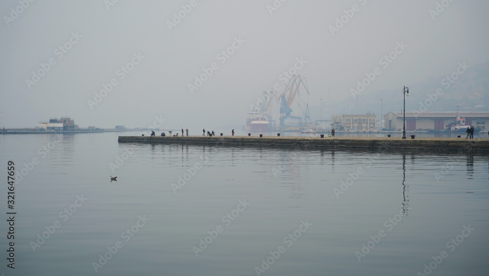 People on the sea pier of Trieste, Italy. People on the sea pier of Trieste, Italy.